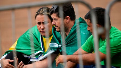 Supporters of outgoing President Jair Bolsonaro watch his farwell video outside the official residence Alvorada Palace in Brasilia on Friday.