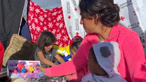 Evelyn Palma receives gifts for her children on the streets of El Paso, Texas.