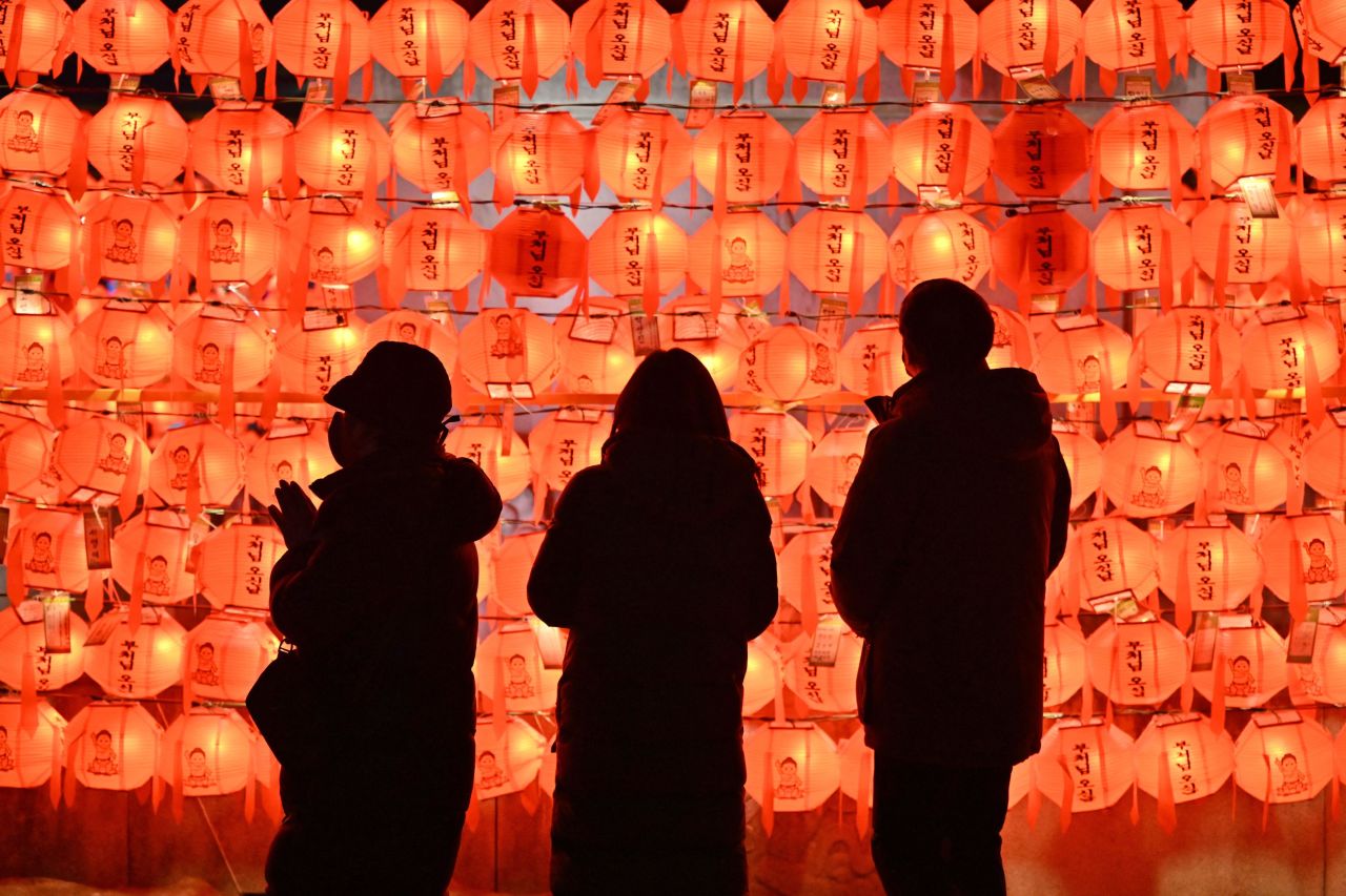 People pray in front of lotus lanterns during celebrations in Seoul, South Korea.