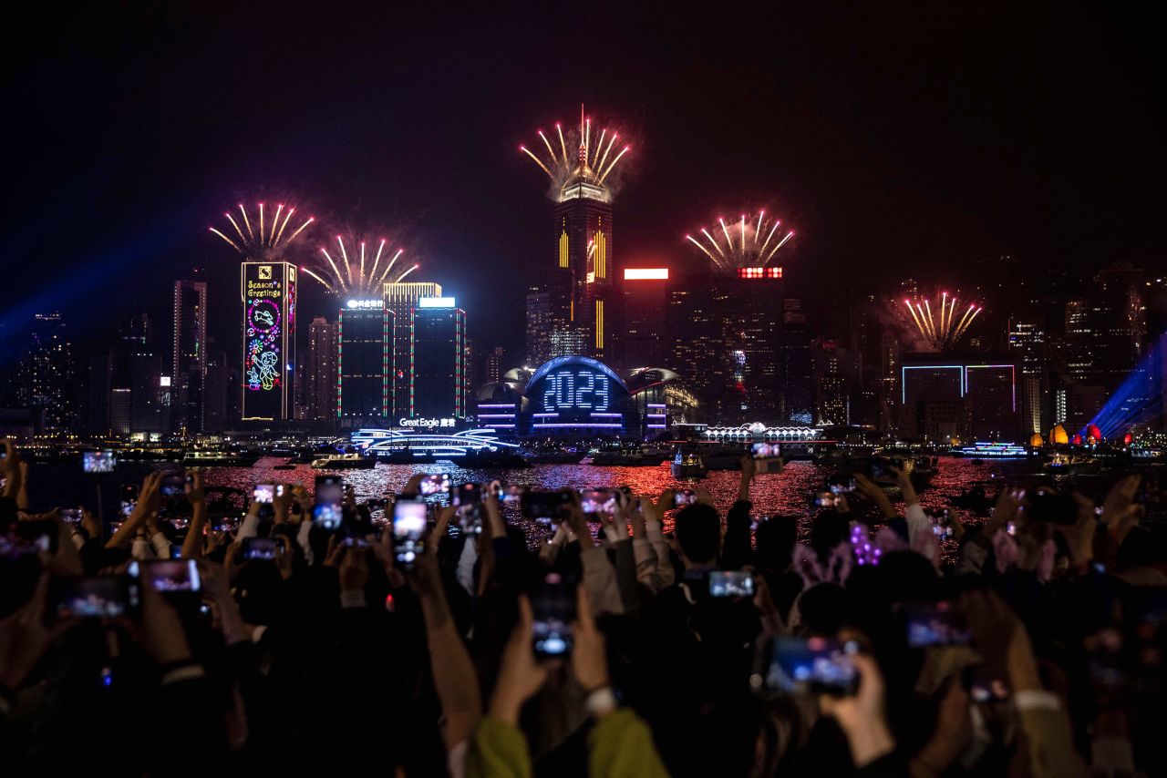 New Year's revelers watch a fireworks and laser show in Hong Kong.