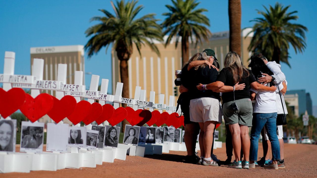 People pray at a makeshift memorial for shooting victims on October 1, 2019, in Las Vegas, on the anniversary of the mass shooting two years earlier.