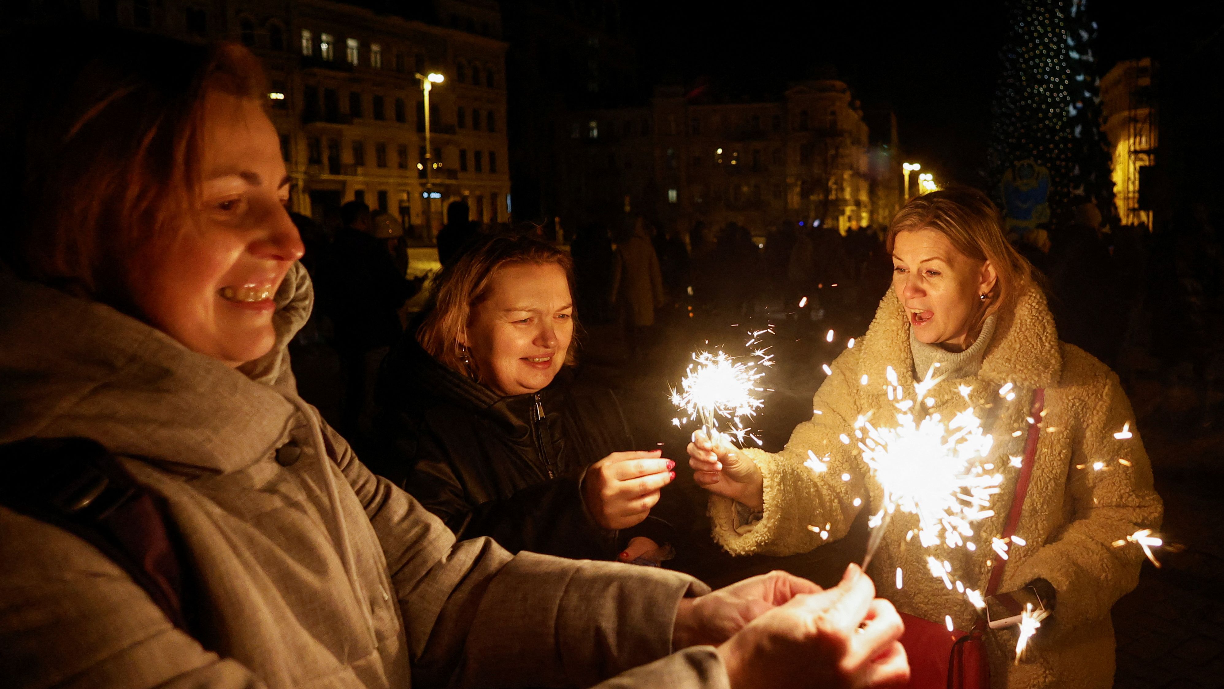 Women celebrate New Year's in front of the St. Sophia Cathedral in Kyiv, Ukraine. There was a curfew in place as Russia launched a series of deadly strikes that swept several regions of Ukraine.