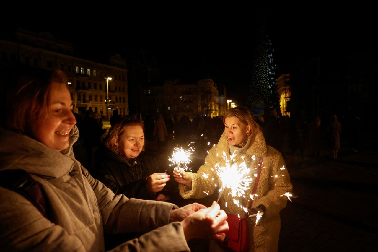 Women celebrate New Year's in front of the St. Sophia Cathedral in Kyiv, Ukraine. There was a curfew in place as Russia launched a series of deadly strikes that swept several regions of Ukraine.