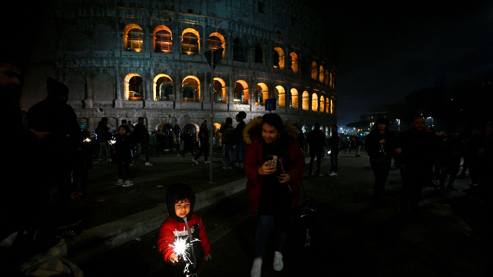 A child celebrates the new year in front of the Colosseum in Rome.