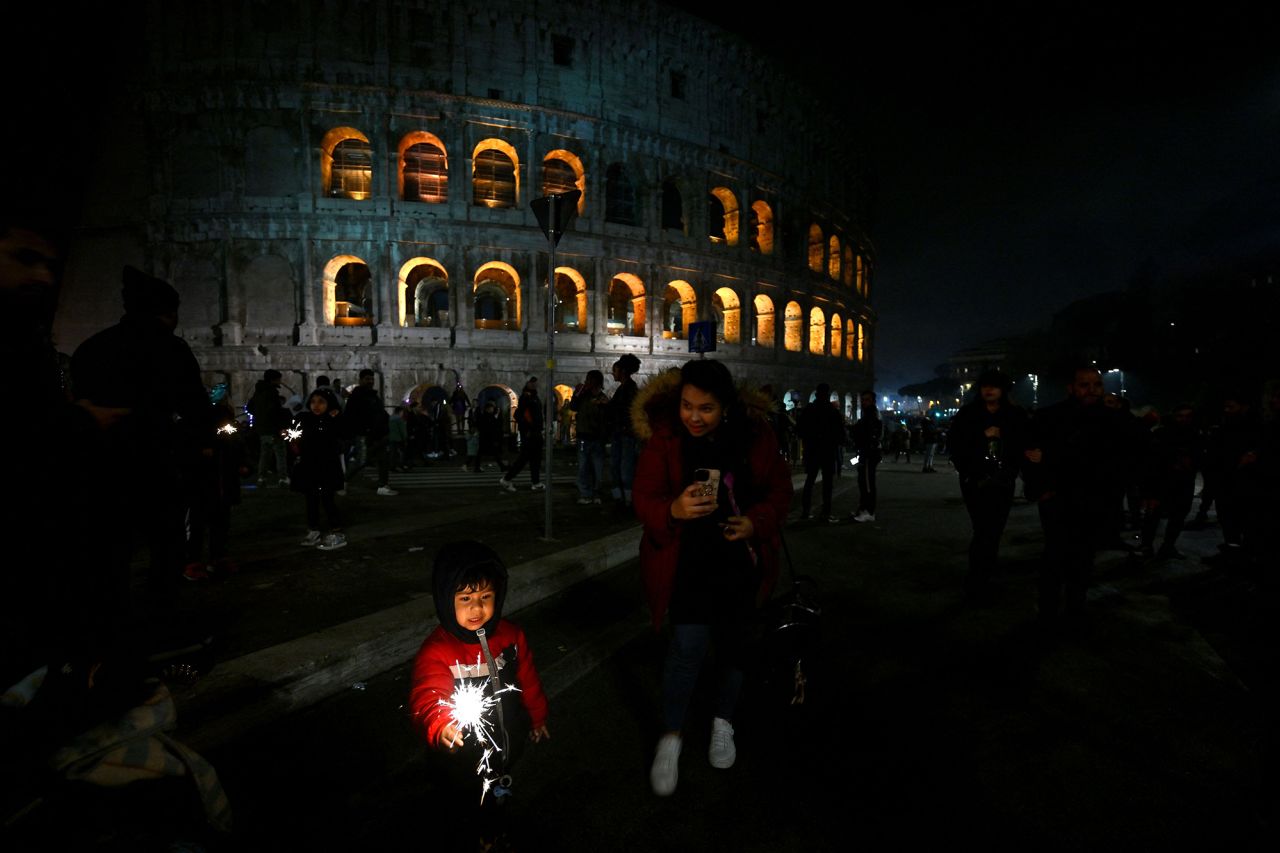 A child celebrates the new year in front of the Colosseum in Rome.