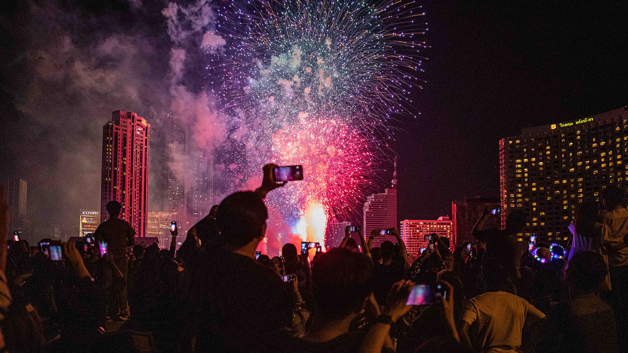 People watch the fireworks in Bangkok, Thailand.