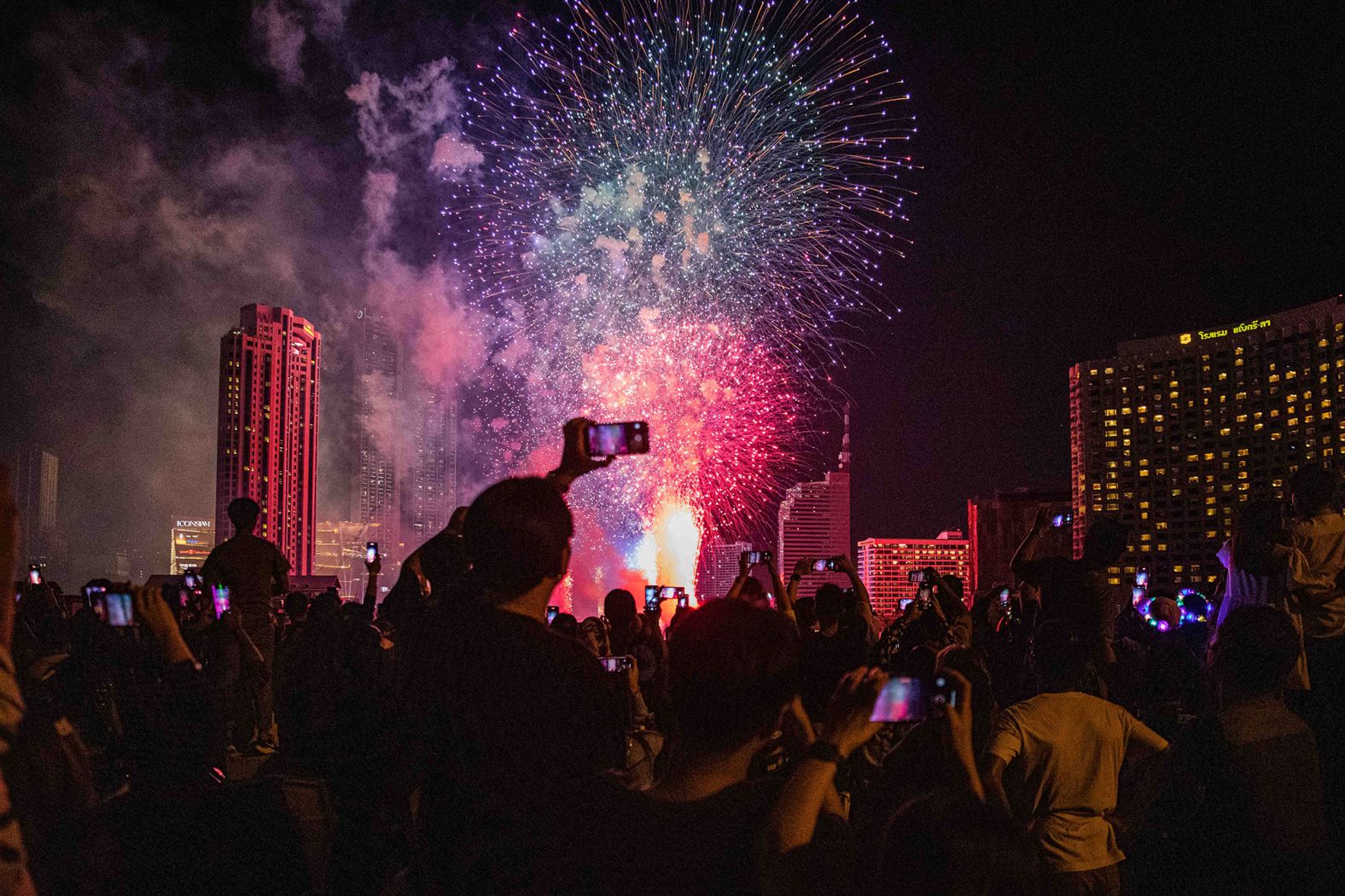 People watch the fireworks in Bangkok, Thailand.