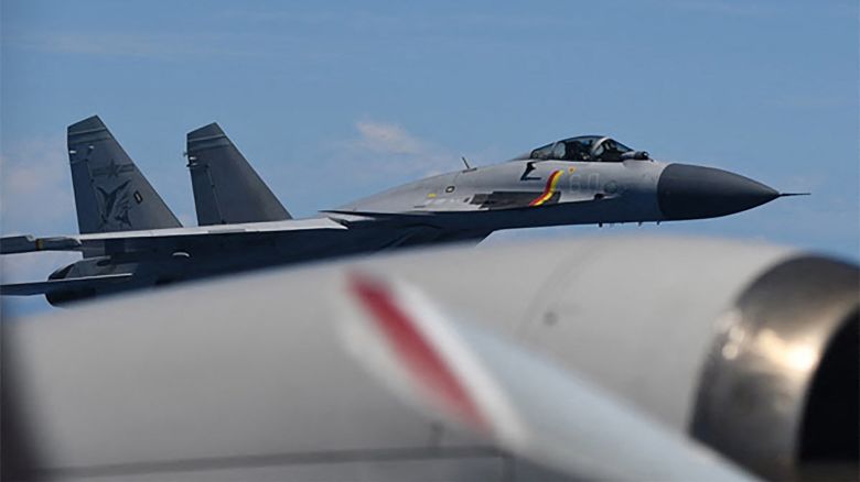 This handout photo taken on June 8, 2025 and received on June 12, 2025 from Japan's Ministry of Defence shows a J-15 fighter jet from the Chinese aircraft carrier Shandong making an unusual approach to a Japan Maritime Self-Defence Force P-3C patrol aircraft that was conducting surveillance above the Pacific Ocean.