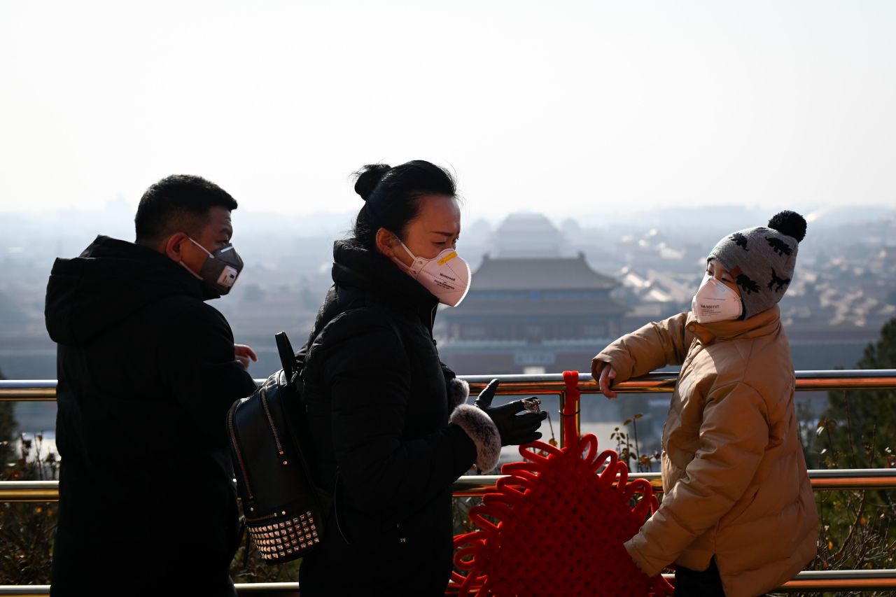 People wearing face masks at a park near the Forbidden City in Beijing on January 31, 2020. 