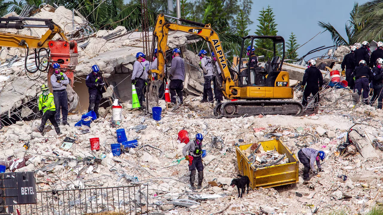 Rescuers search for victims at a collapsed South Florida condo building Monday, July 5, in Surfside, after demolition crews set off a string of explosives that brought down the last of the Champlain Towers South building in a plume of dust on Sunday. 