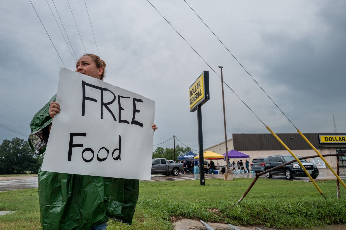 A volunteer displays a "free food" sign for people in Center Point.