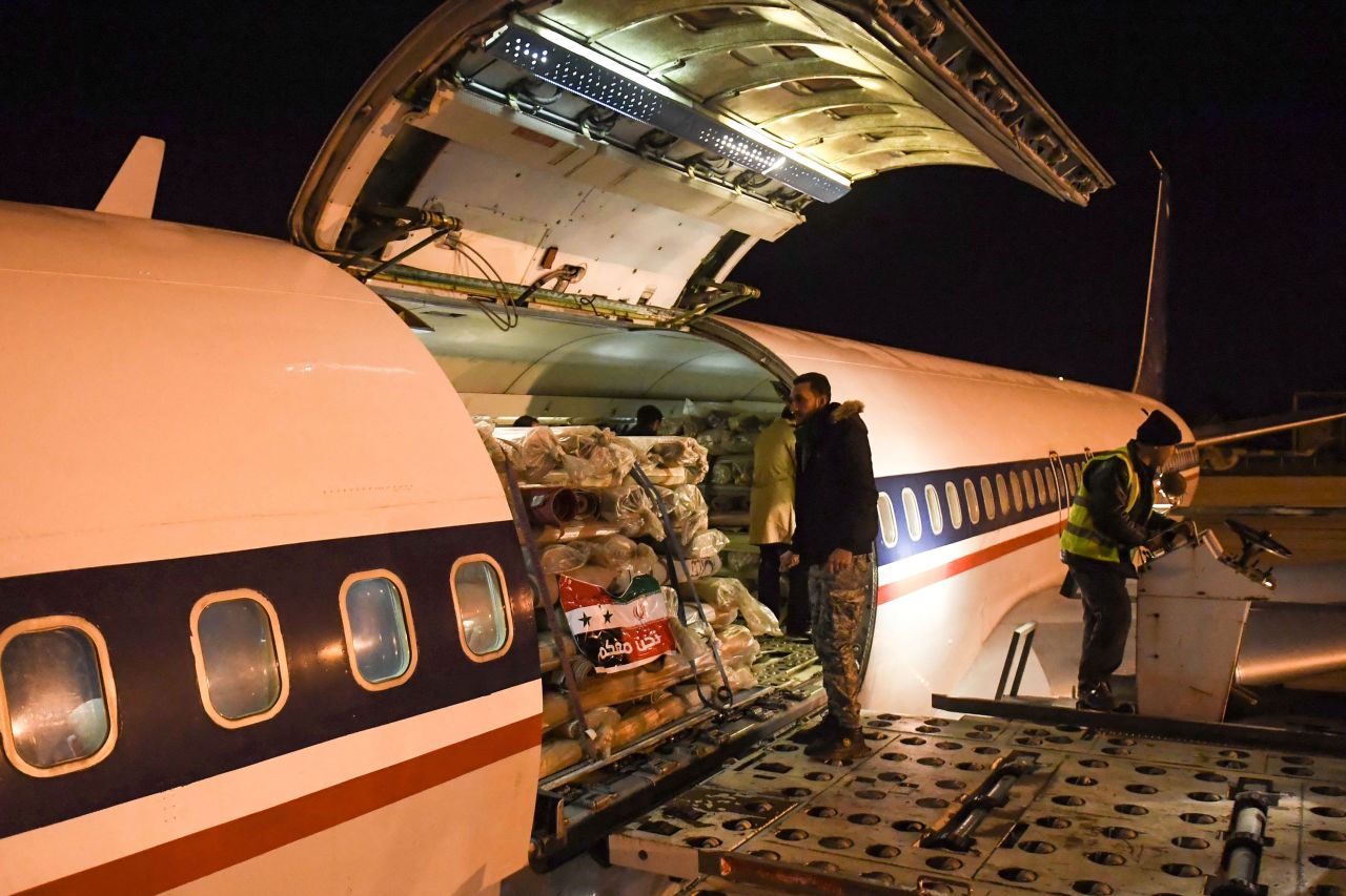 Workers unload aid sent by Iran at the Aleppo airport on Wednesday.