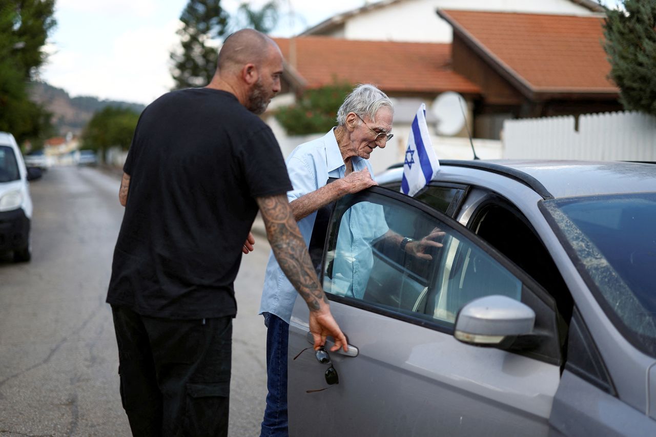 A man assists his elderly father to be evacuated from Kiryat Shmona, near Israel's border with Lebanon, in northern Israel, on October 20.