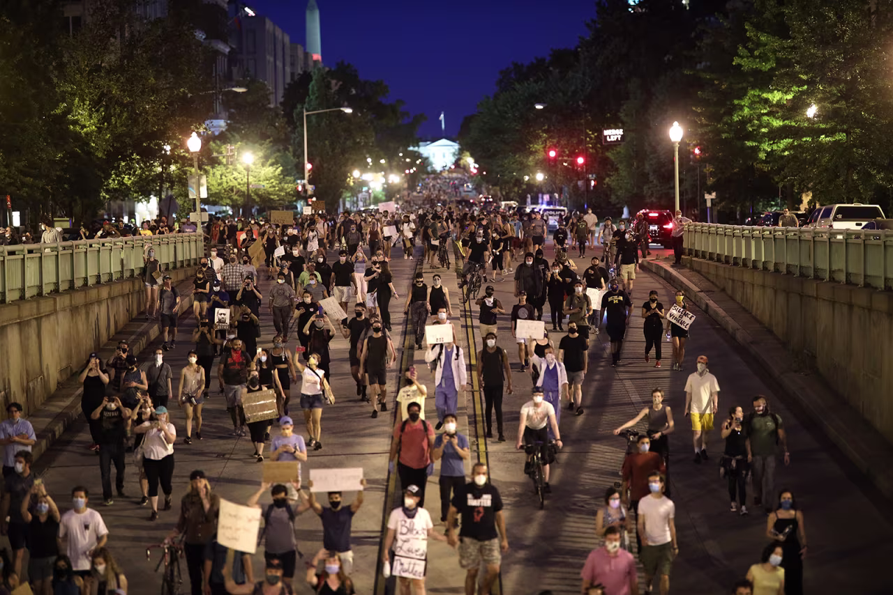 Demonstrators march away from the White House during a peaceful protest against police brutality and the death of George Floyd, on June 3, in Washington, DC.