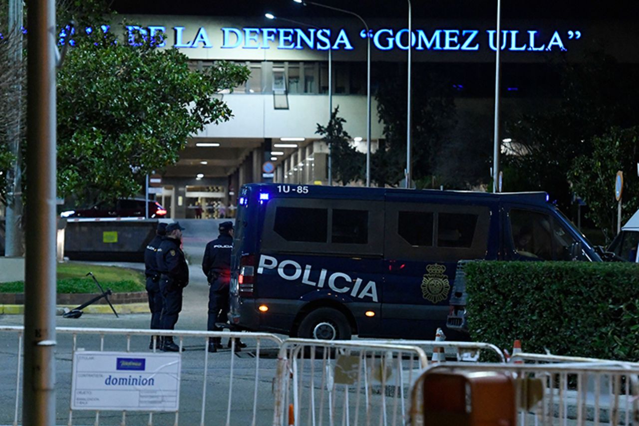 Police officers stand outside the Gomez Ulla Military Hospital in Madrid, on Friday, January 31, after the arrival of the Spanish nationals evacuated from the Chinese city of Wuhan.