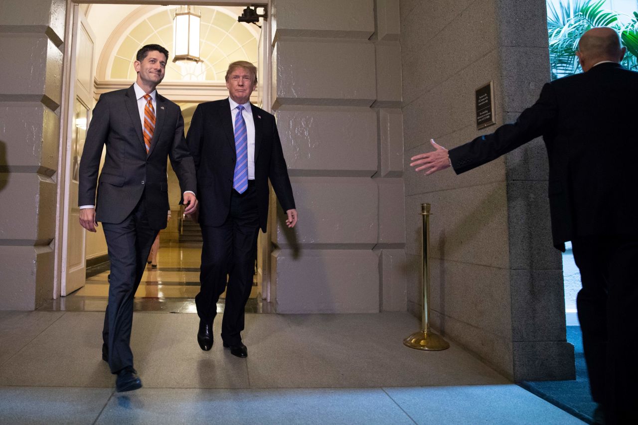 Trump, accompanied by House Speaker Paul Ryan, arrive for a meeting with Republican members of Congress on Tuesday.