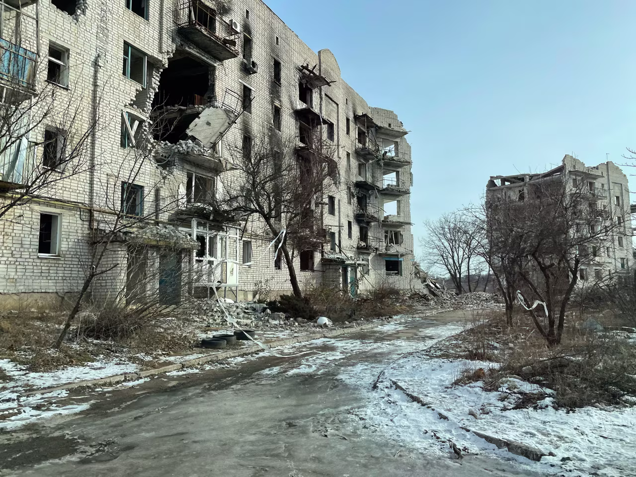 Destroyed buildings are seen in Izium.