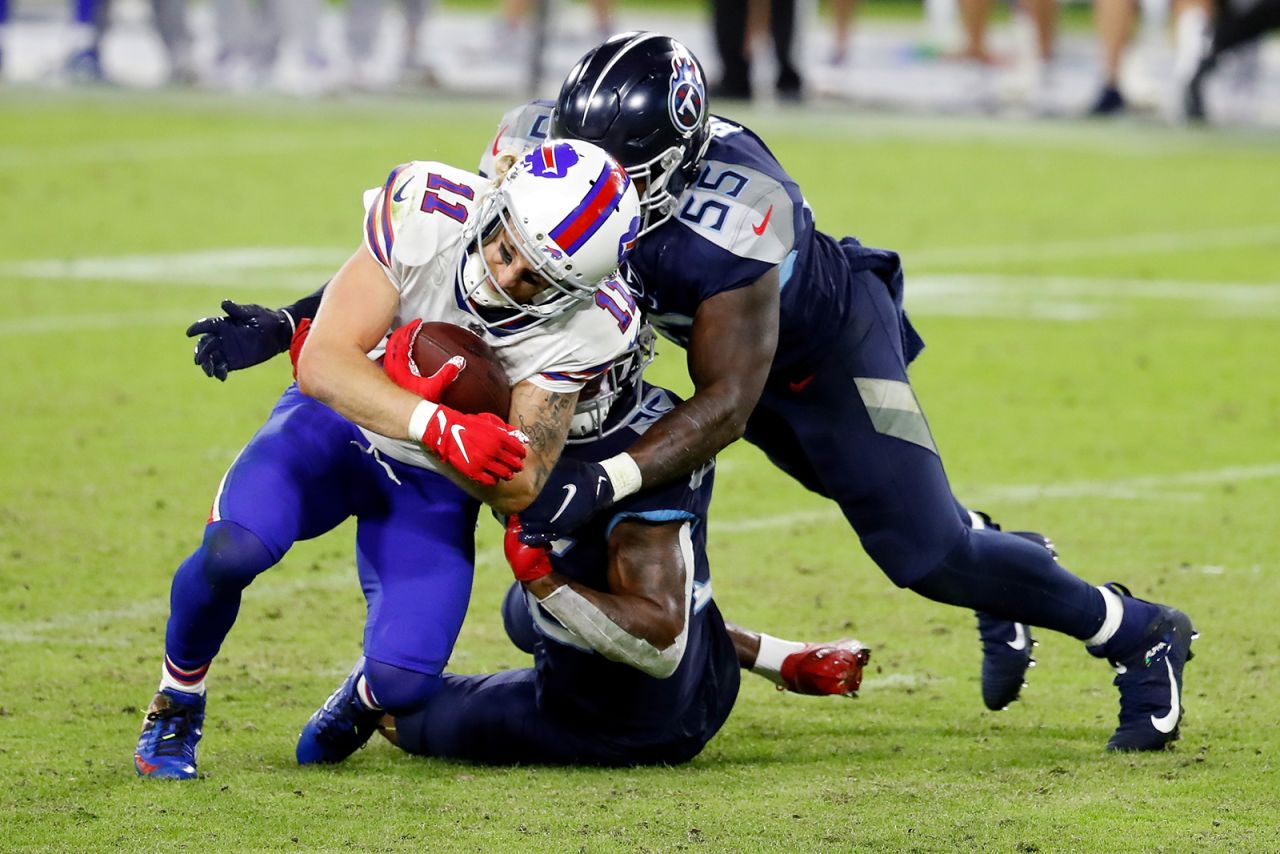 Cole Beasley of the Buffalo Bills runs with the ball while being tackled by Jayon Brown of the Tennessee Titans in the fourth quarter at Nissan Stadium on October 13, in Nashville, Tennessee. 