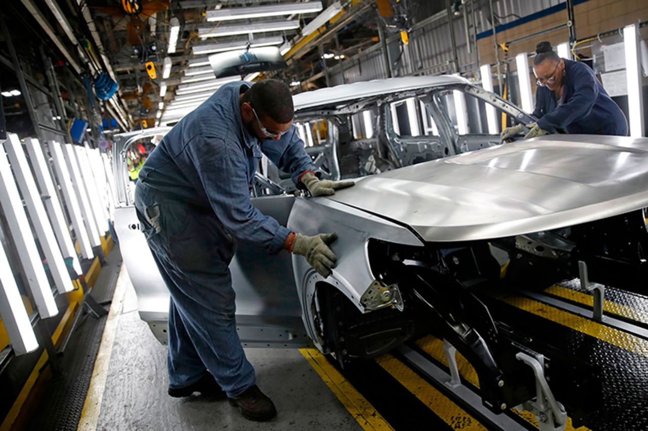 Workers assemble cars at the newly renovated Ford's Assembly Plant in Chicago, June 24, 2019.