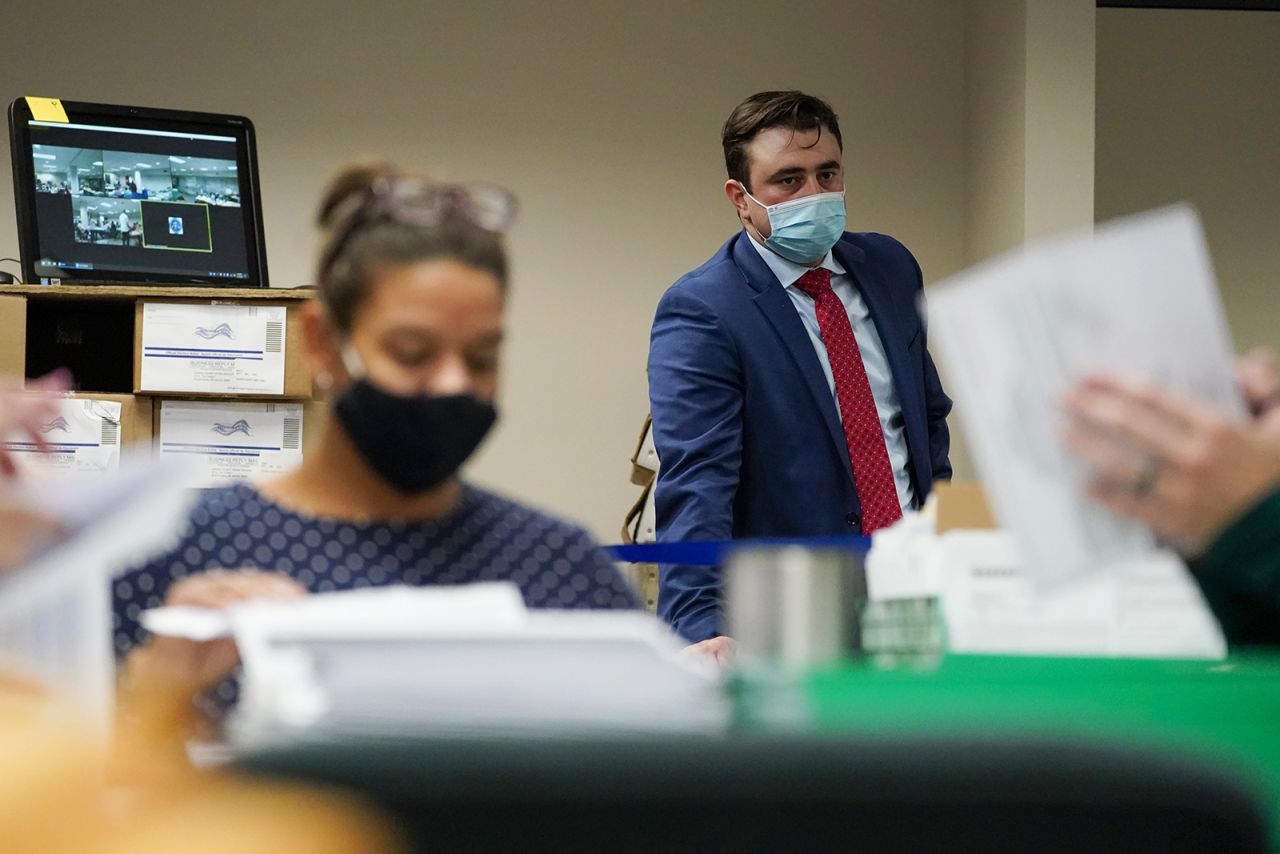 A Republican observer watches as Lehigh County workers count ballots as vote counting in the general election continues on Thursday, November 5, in Allentown, Pennsylvania. 