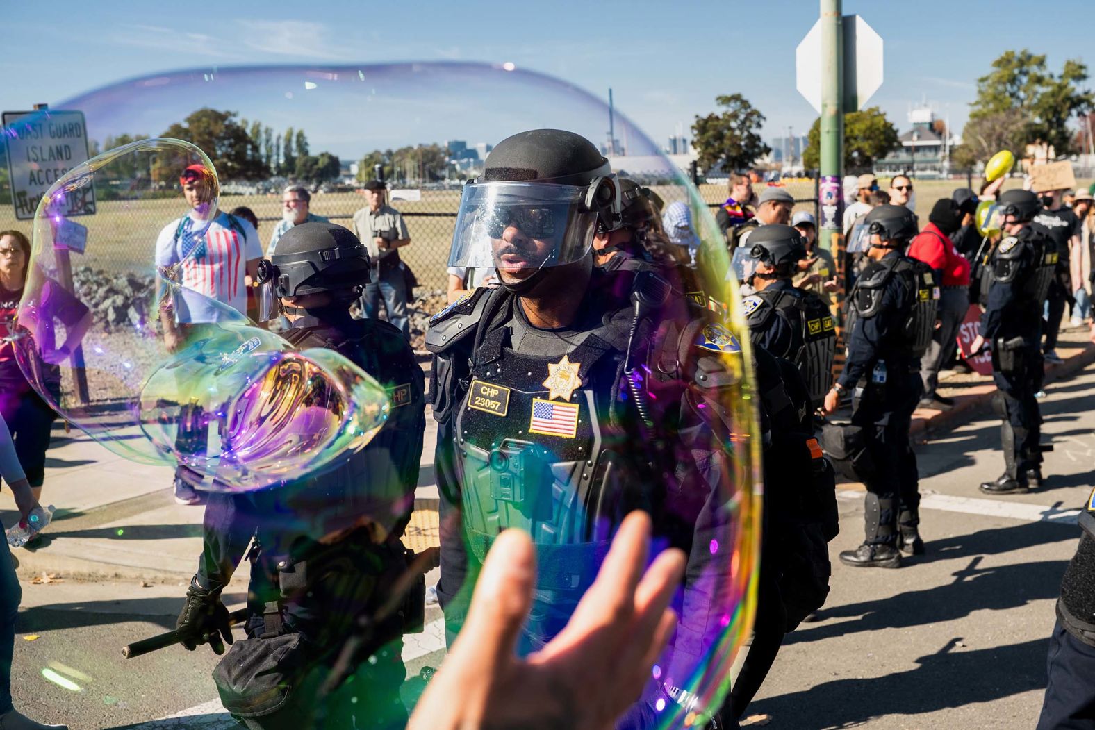 California Highway Patrol officers move back protesters who were blocking the entrance to a US Coast Guard base in Alameda County, California, on Thursday, October 23. Protesters had been <a href="index.php?page=&url=https%3A%2F%2Fwww.cnn.com%2Fus%2Flive-news%2Fnational-guard-deployment-immigration-raids-10-23-25-hnk%3Fpost-id%3Dcmh3k5mvo000q356n72sa4i8b">blocking vehicles from the US Customs and Border Protection</a>.