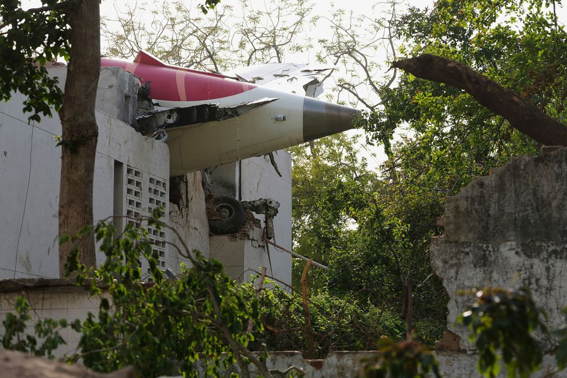 The tail of the airplane can be seen stuck in a building in Ahmedabad, Gujarat on June 12, 2025.