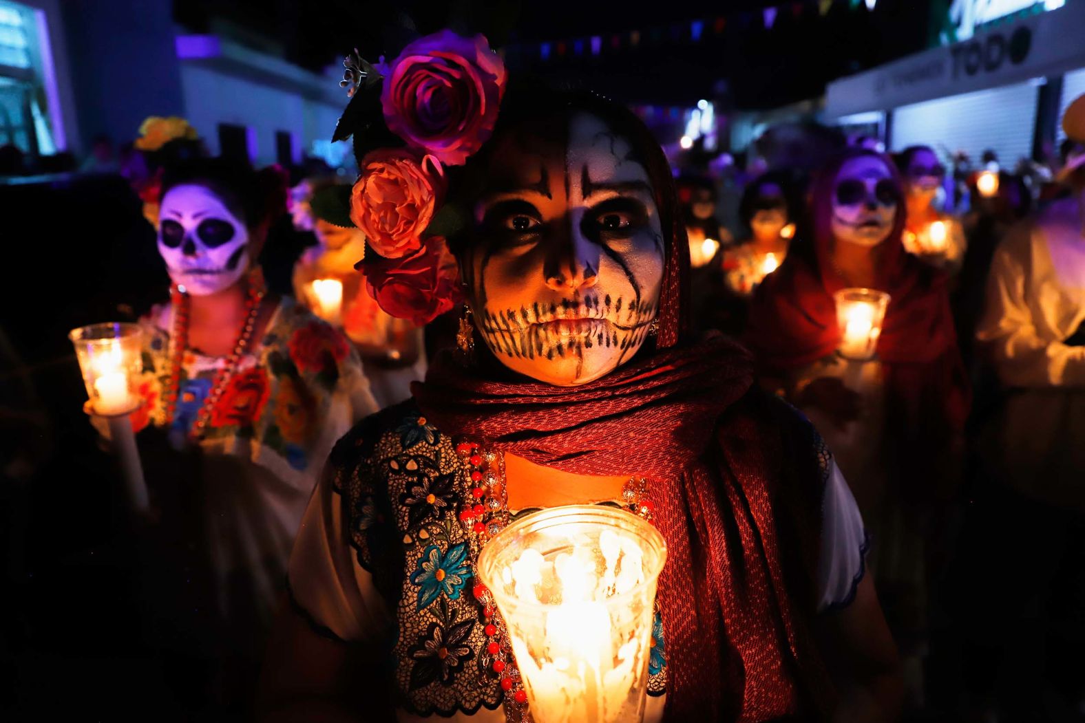 People wearing skull makeup march during a Day of the Dead parade in Merida, Mexico, on Friday, October 31.