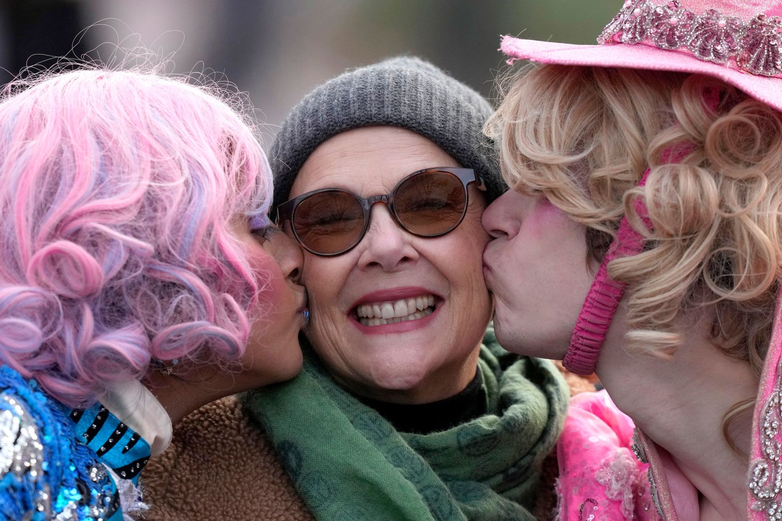 Actress Annette Bening receives a kiss from Harvard University theatrical students Nikita Nair, left, and Joshua Hillers during a parade in Cambridge, Massachusetts, on Tuesday, February 6. Bening was named Hasty Pudding Woman of the Year by the university’s Hasty Pudding Theatricals troupe.