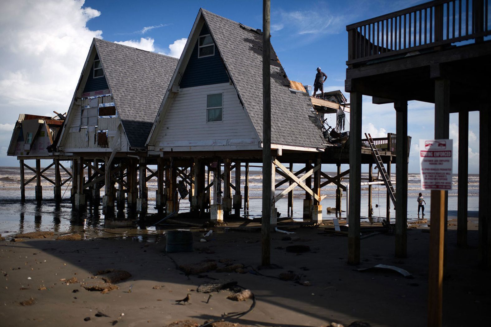A man surveys damage at a home in Surfside Beach, Texas, after Hurricane Beryl swept through the area on Monday, July 8.