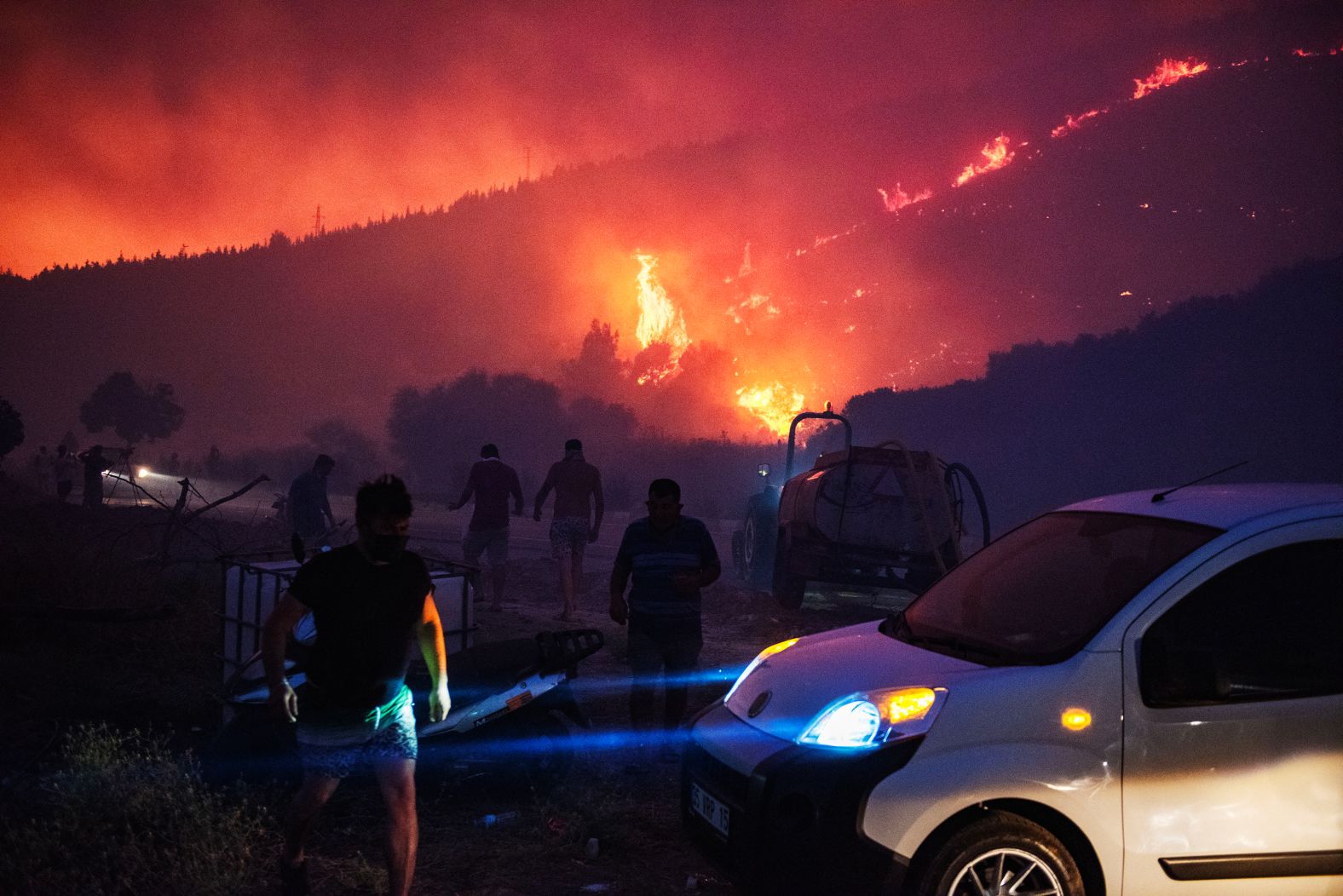 Firefighters and residents attempt to extinguish <a href="index.php?page=&url=https%3A%2F%2Fwww.cnn.com%2F2025%2F07%2F01%2Fworld%2Fvideo%2Fturkey-wildfires-evacuations-digvid">a wildfire</a> in Izmir, Turkey, on Monday, June 30. More than 50,000 people have evacuated the area because of the wildfires.