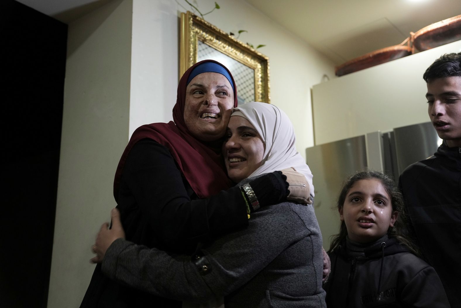 Israa Jaabis, left, is hugged as she arrives home in East Jerusalem on November 26 after being released by Israel as part a prisoner-hostage exchange. Jaabis had been convicted of an "attempt to cause grievous bodily harm with aggravated intent," according to the New York Times, citing her lawyer. Jaabis was arrested in 2015 after her car exploded near a West Bank checkpoint, leaving her and an Israeli police officer with serious injuries. She said the explosion was due to a gas container for cooking she had in her car that day, and that the fire started without her knowledge, according to Palestinian prisoner's rights group Addameer.