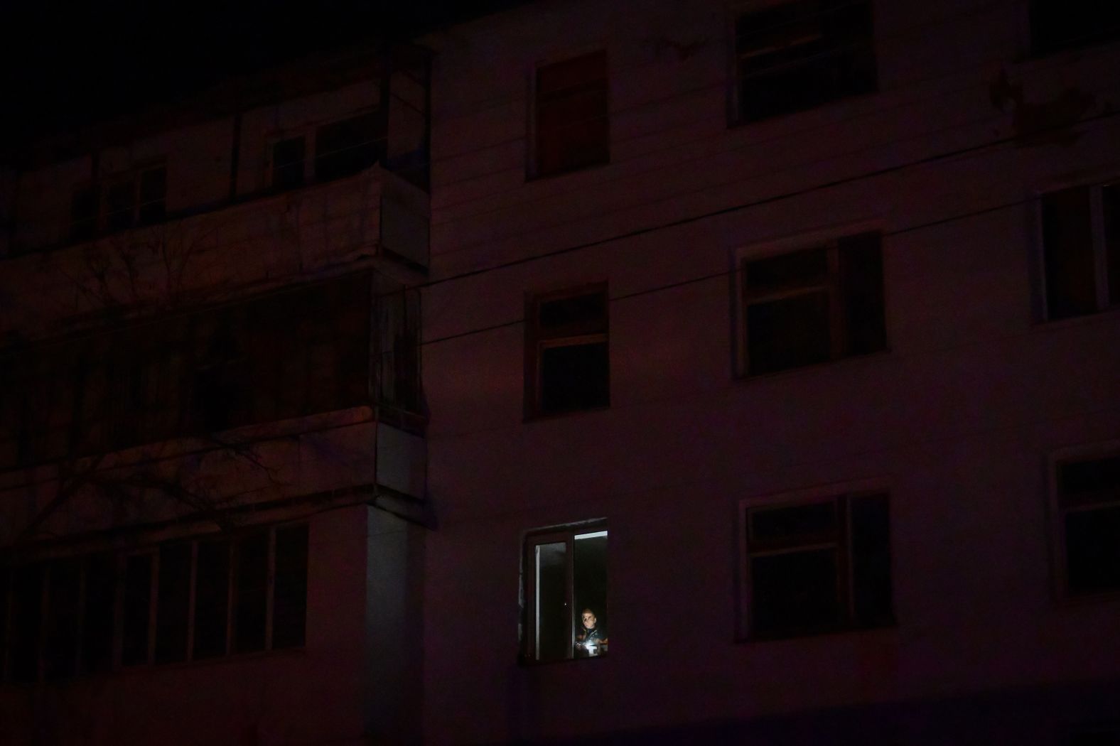 A man holds a lantern at his apartment’s window during a programmed power outage in Varniţa, Moldova, on Friday, January 17. There has been an <a href="index.php?page=&url=https%3A%2F%2Fwww.cnn.com%2F2025%2F01%2F10%2Feurope%2Ftransnistria-energy-crisis-moldova-russia-explainer-intl%2Findex.html">energy crisis in Moldova</a>, which was almost entirely reliant on Russian gas before Russia invaded Ukraine. Moldova has had to buy from emergency European markets – mostly via Romania – at nearly twice the price.