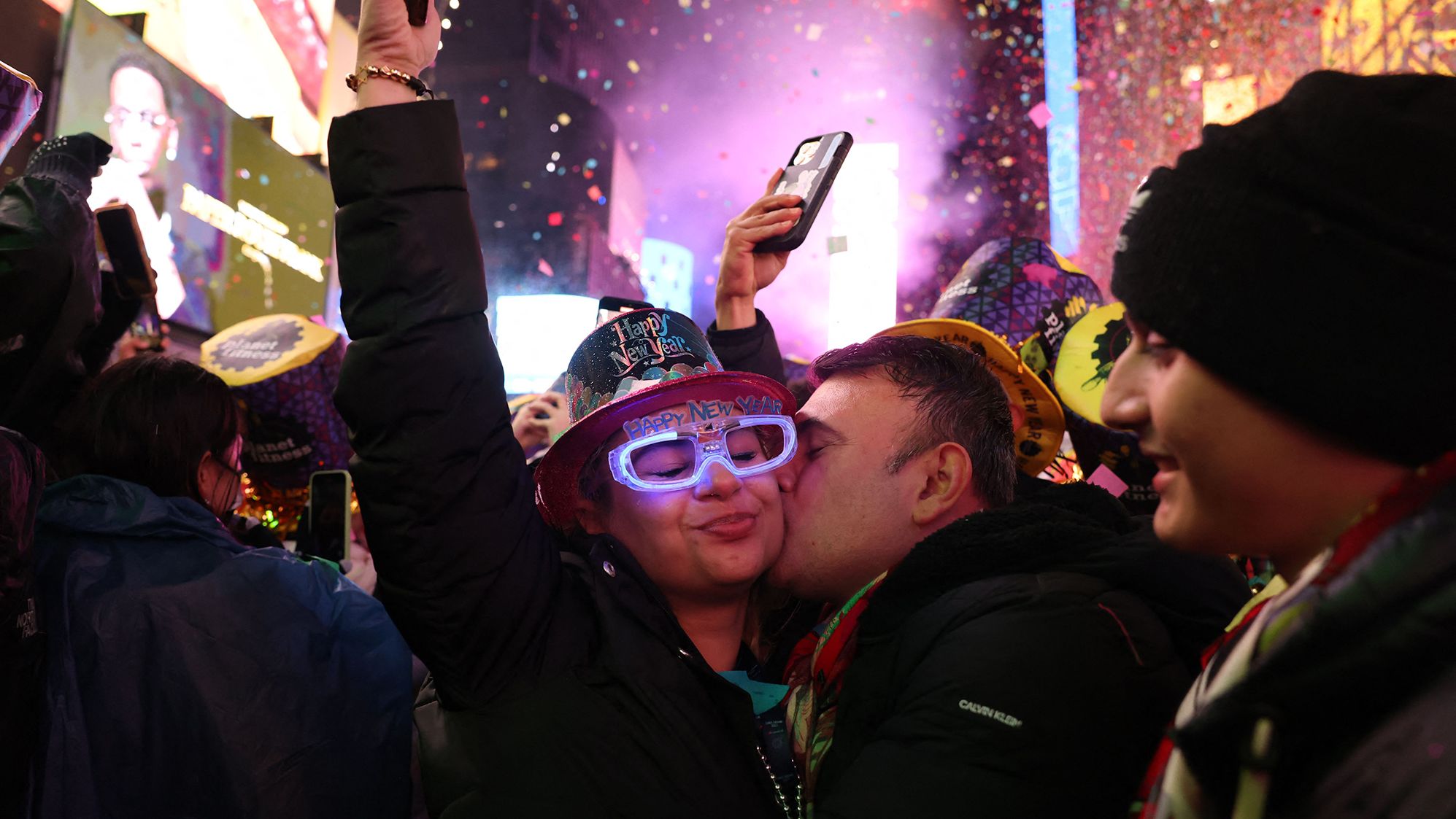 People kiss as confetti falls to mark the new year in New York's Times Square.