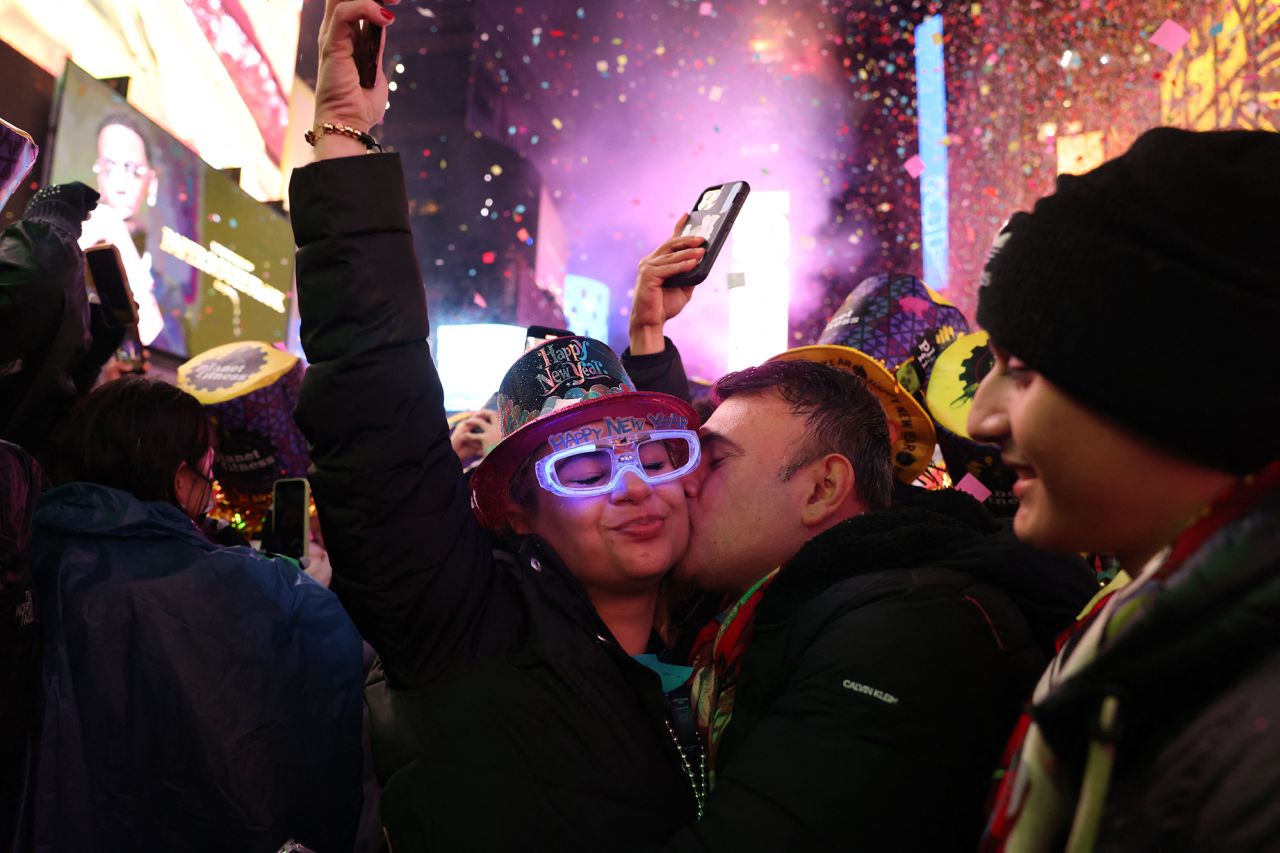 People kiss as confetti falls to mark the new year in New York's Times Square.