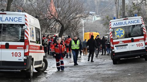 Medics and policemen worked next to houses which were partially destroyed by a Russian strike in the Ukrainian capital, Kyiv, on New Year's Eve. 