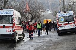 Medics and policemen worked next to houses which were partially destroyed by a Russian strike in the Ukrainian capital, Kyiv, on New Year's Eve. 