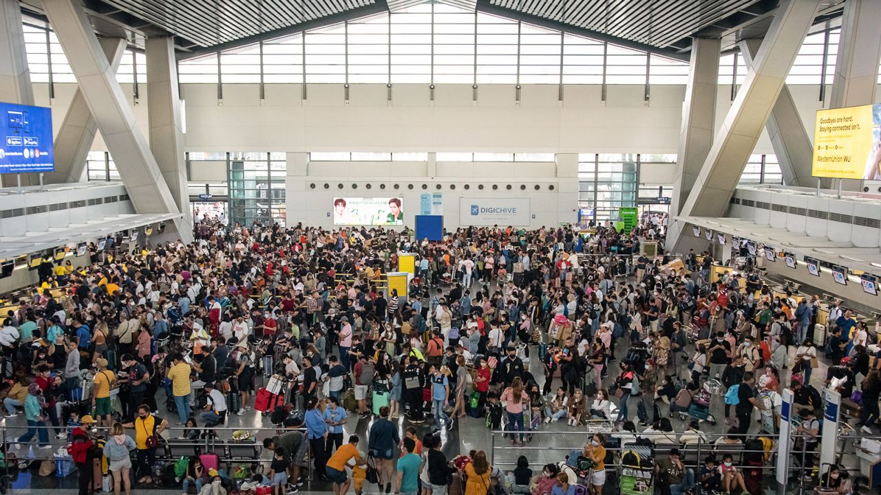 Passengers wait for information about their flights at the of Ninoy Aquino International Airport in Metro Manila, Philippines on January 1, 2023. 
