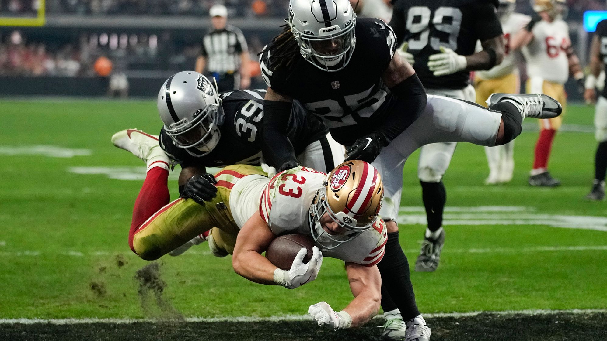 San Francisco running back Christian McCaffrey rumbles into the end zone against Las Vegas on January 1. McCaffrey and the Niners won 37-34 in overtime.