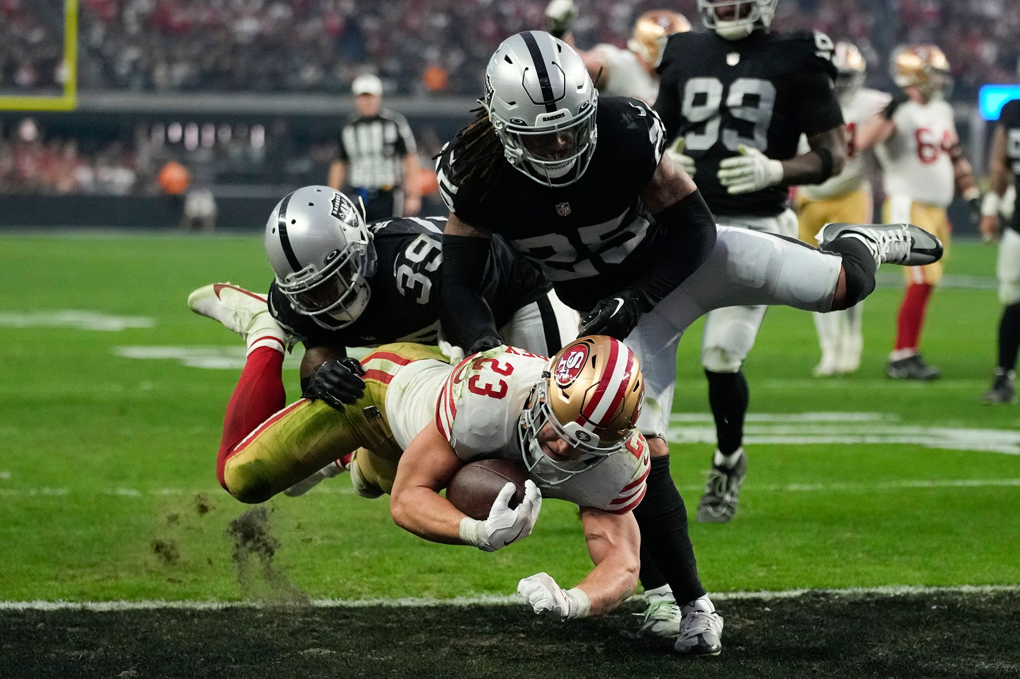 San Francisco running back Christian McCaffrey rumbles into the end zone against Las Vegas on January 1. McCaffrey and the Niners won 37-34 in overtime.