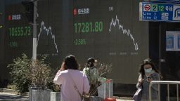 A public screen displays the Shenzhen Stock Exchange and the Hang Seng Index figures in Shanghai, China, on Monday, Oct. 10, 2022. 