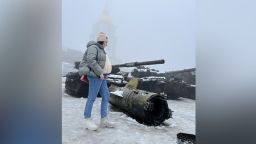 Kateryna stands in front of seized Russian equipment on Sofiyivska Square, Kyiv