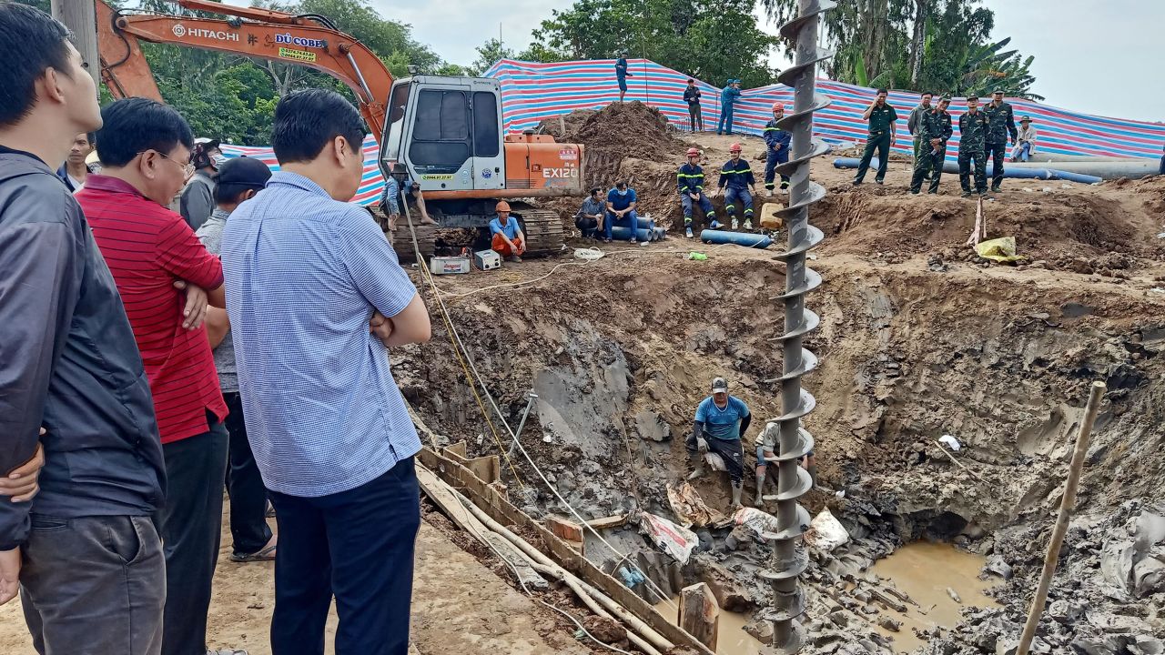 Rescuers at the site where the boy is trapped in Vietnam's Dong Thap province on January 2, 2023.