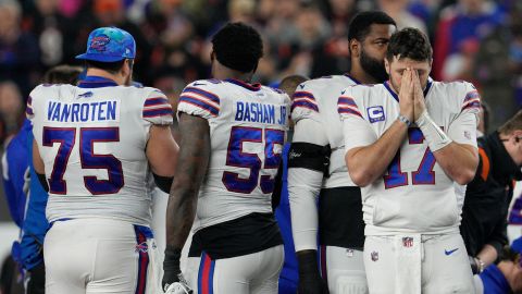 Buffalo Bills quarterback Josh Allen (17) stands on the field as Hamlin is treated.