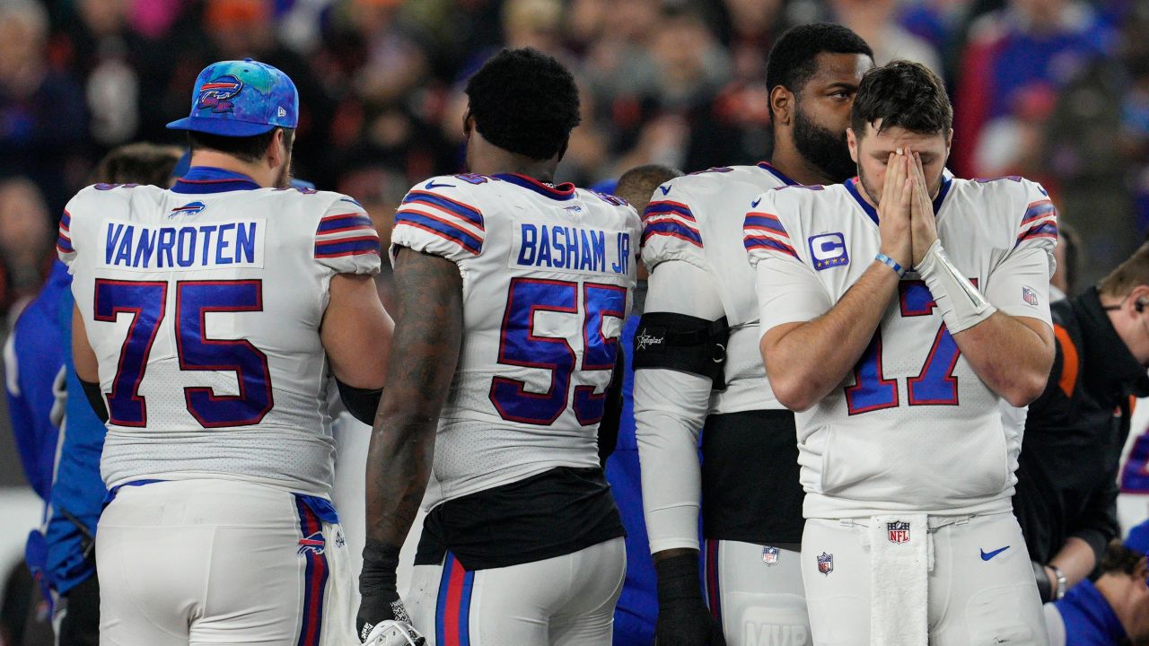 Buffalo Bills quarterback Josh Allen (17) stands on the field as Hamlin is being treated.
