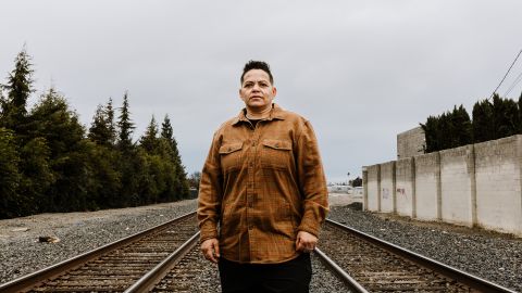 Natasha LaTour, believed to be the sole survivor of a suspected serial killer, stands on the railroad tracks next to where she was shot in Stockton, California.