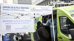 A man gets himself tested for coronavirus (COVID-19) in front of portable cabin as people began wearing mask after New York City's health officials have issued an advisory, strongly urging New Yorkers to use masks as COVID-19, flu, and RSV cases rise, on December 12, 2022 in New York, United States. 