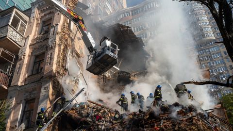 Firefighters work after a drone attack on buildings in Kyiv, Ukraine, Oct. 17, 2022.