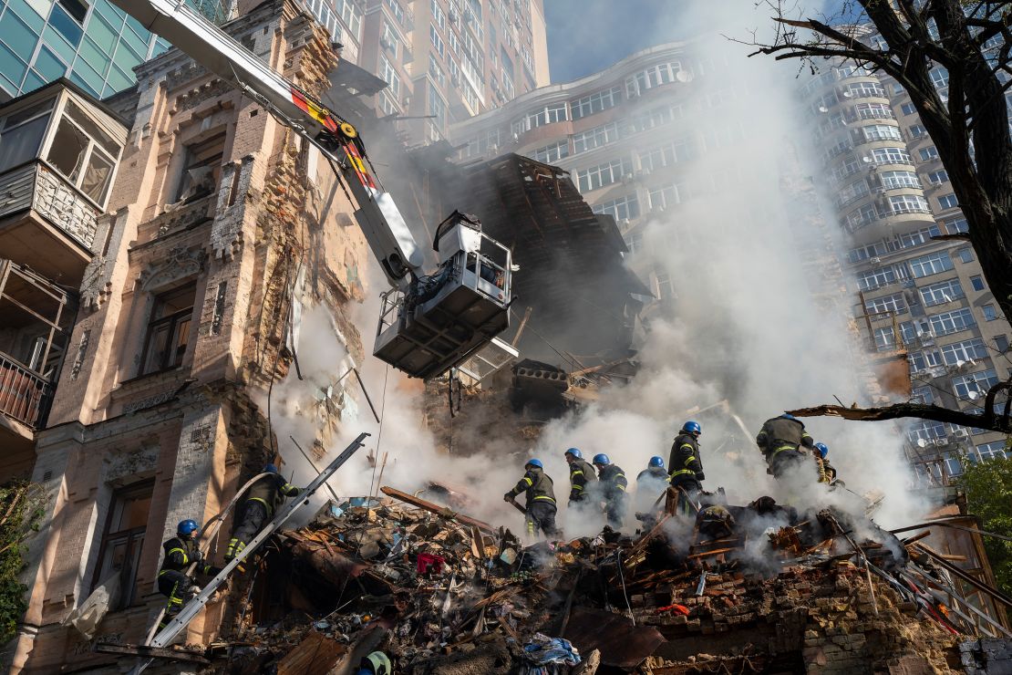 Firefighters work after a drone attack on buildings in Kyiv, Ukraine, Oct. 17, 2022.