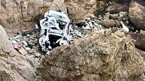This image provided by the San Mateo County Sheriff's Office shows the Tesla on a rocky beach below the cliffs, an area called Devil's Slide. 