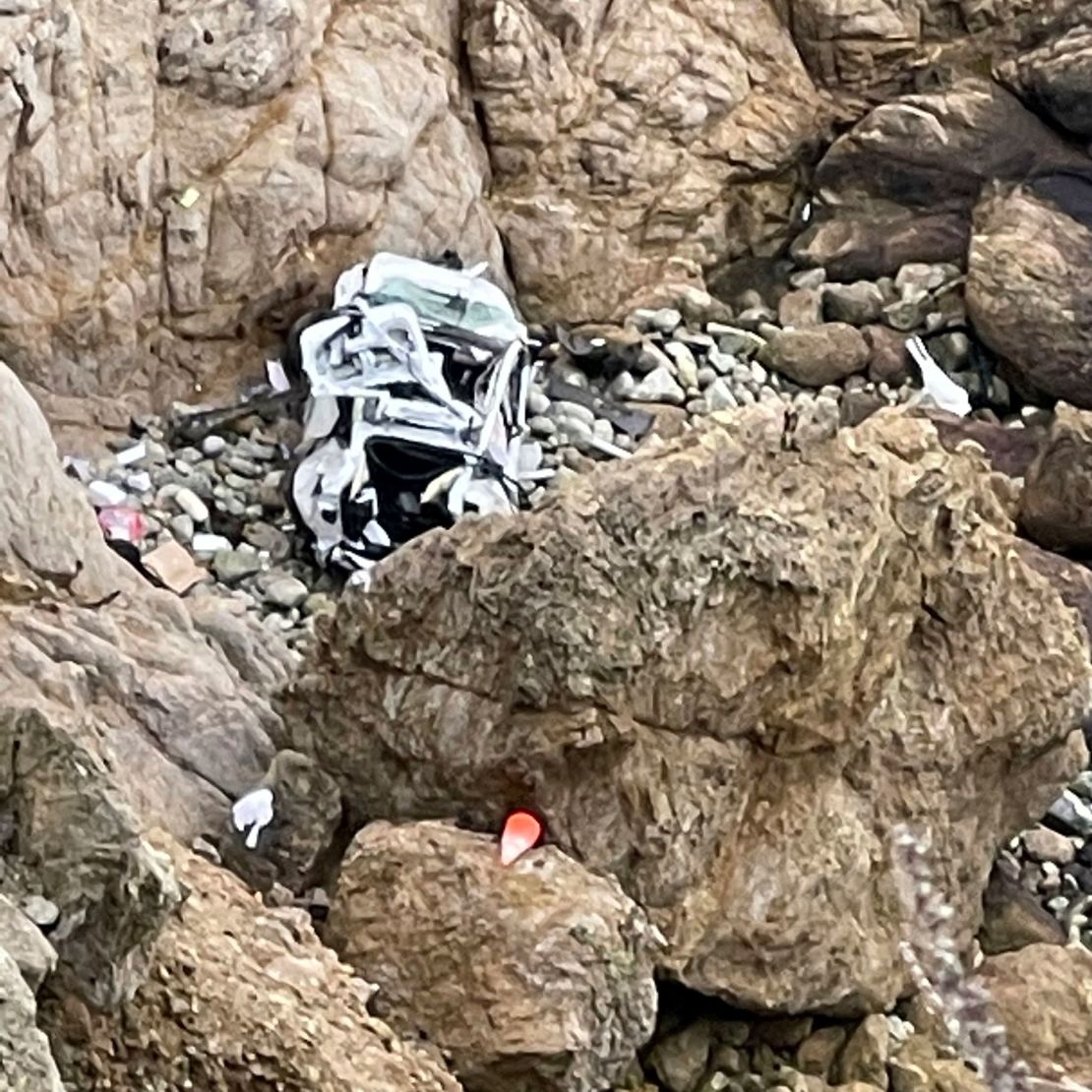 This image provided by the San Mateo County Sheriff's Office shows the Tesla on a rocky beach below the cliffs, an area called Devil's Slide. 
